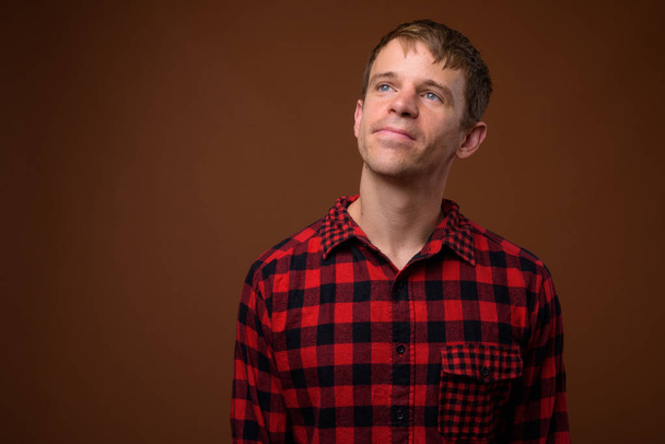 Man wearing red checkered shirt and thinking - Foto, immagini
