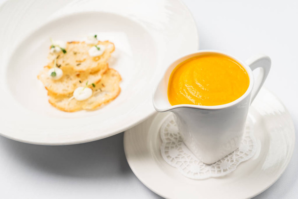 Pumpkin and carrot soup with cream with croutons on the white background - Foto, Imagen