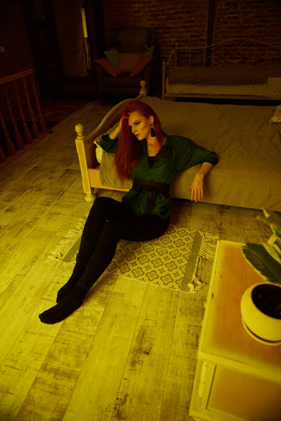 Vintage photo of Beautiful red haired young woman posing in old loft apartment in Tbilisi - Foto, imagen