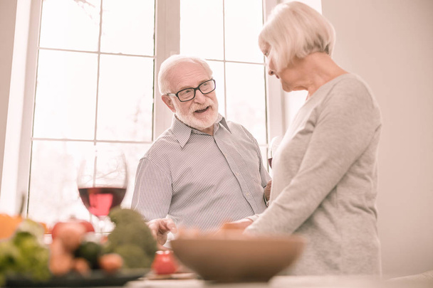 Positive delighted senior people being in kitchen - Photo, Image