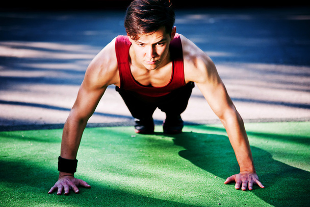 Young man doing fitness exercise - Photo, image