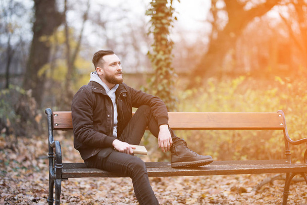 Hipster man daydreaming on a bench - Фото, зображення