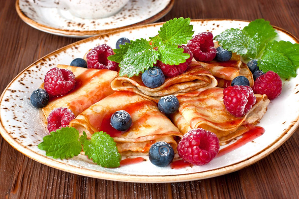 Golden crepes with   raspberry and blueberry. Traditional crepes for pancake week  - Valokuva, kuva