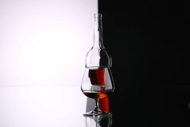 arka planda brendi ve şarap için gözlük ve şişeler - Fotoğraf, Görsel