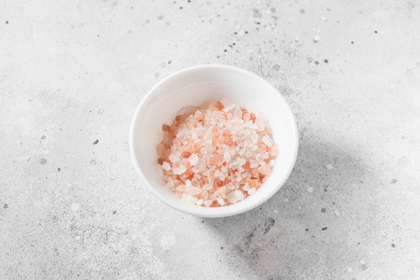 Pink sea salt on a light gray background - Fotografie, Obrázek
