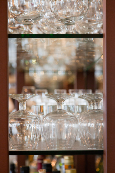Empty wine glasses in bar rack. - Fotografie, Obrázek