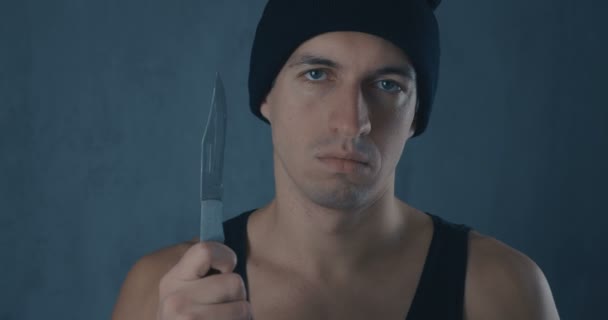Portrait of Dangerous man in a cap with a knife - Footage, Video