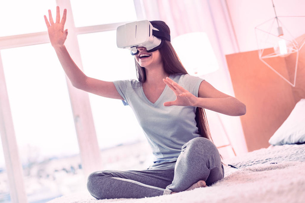 Young girl wearing modern virtual reality glasses - Photo, image