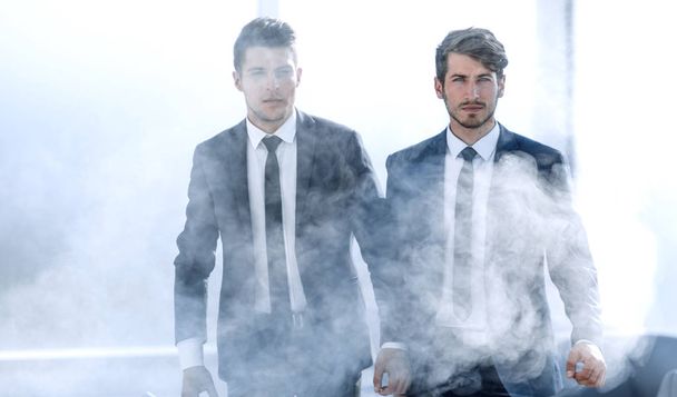 businessmen leave the office in smoke - 写真・画像