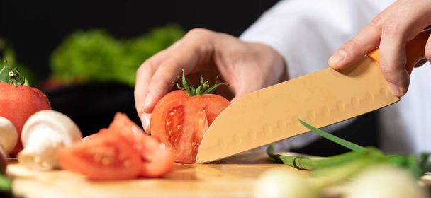 Chef prepares fresh vegetables. Cooking, healthy nutrition concept - Fotó, kép