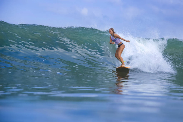 Young woman on blue wave - Foto, Imagen