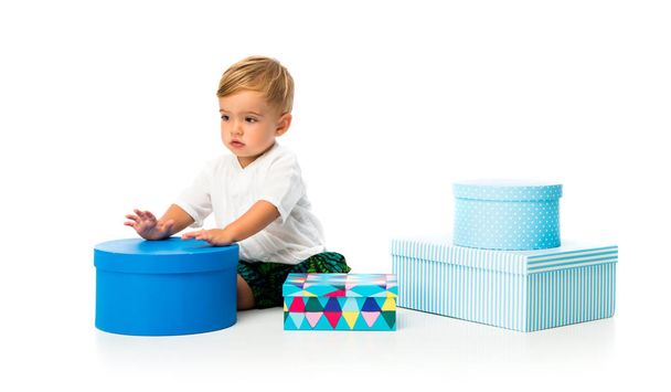 Rozkošné miminko v jeho narozeniny se spoustou dárků na izolované bílém pozadí - Fotografie, Obrázek