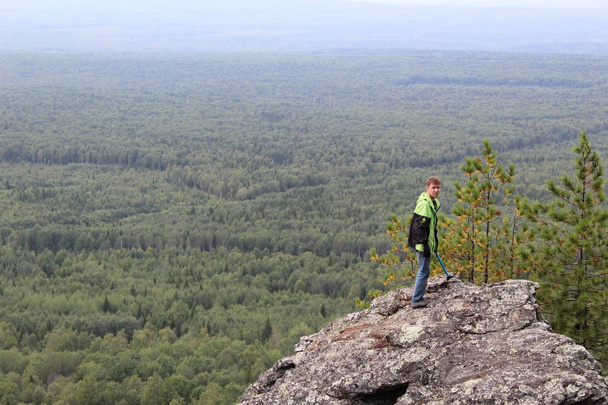 tourist on top of the mountain / beautiful landscape of the Ural mountains in the Perm region, mount Kolpaki.Tourists like Hiking in the mountains, accessible area.From the height of a beautiful view of nature.The photo shows a man on top . - Valokuva, kuva
