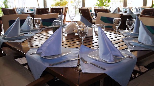 a decorated dinner table. Scene. Beautiful table decoration in the restaurant in the summer. Restaurant interior - Photo, Image