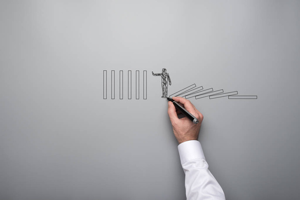 Mannenhand tekeningshape van een zakenman die grijze achtergrond in een conceptuele afbeelding stoppen domino-effect. Met kopie ruimte. - Foto, afbeelding