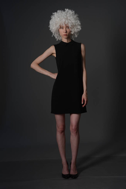 bald girl posing in Studio in black dress - Fotografie, Obrázek