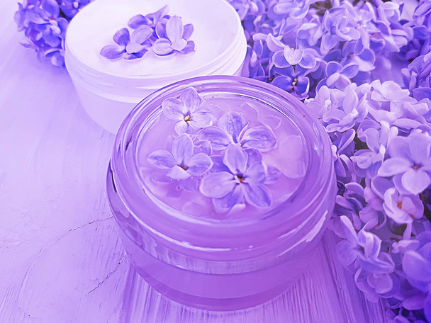 cosmetic cream, lilac flower on wooden background - Photo, Image