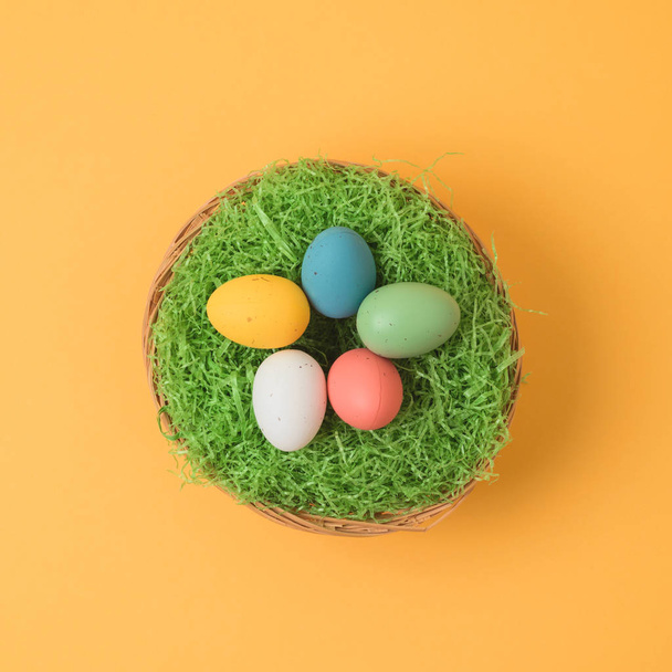 Easter holiday concept with easter eggs in basket decorations. Minimal concept.Top view from above. Flat lay - Фото, зображення