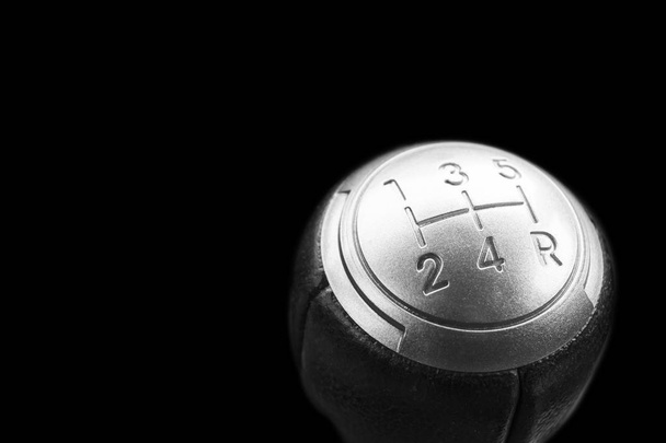 Close up view of a manual gear lever shift isolated on black background. Manual gearbox. Car interior details. Car transmission. Soft lighting. Abstract view. Car detailing - Photo, Image