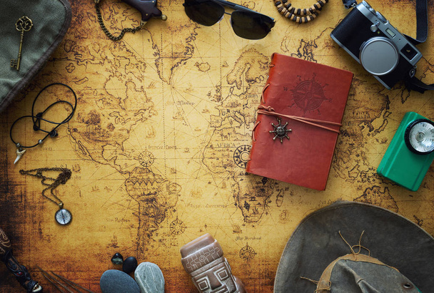 Old map, vintage travel equipment and souvenirs from the travel around the world - Photo, Image