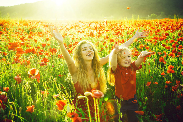 girl and little boy or child in field of poppy - 写真・画像