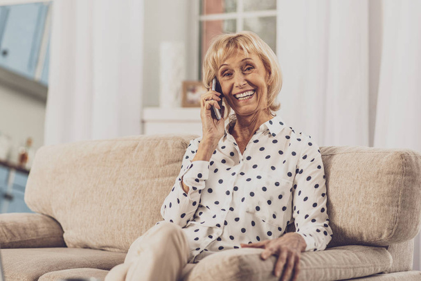 Delighted senior female person talking per telephone - Фото, изображение