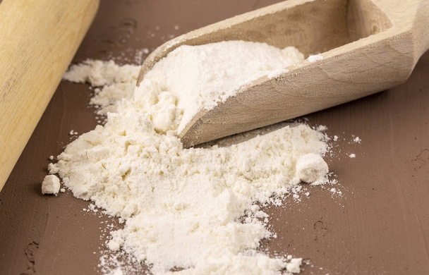 the flour in the wooden scoop  - Photo, Image