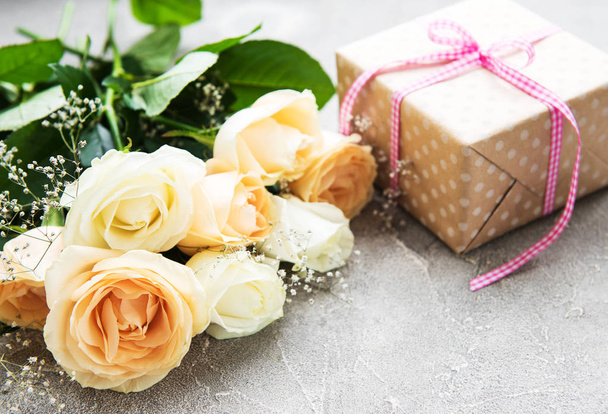 Roses and gift box on a stone background - Zdjęcie, obraz