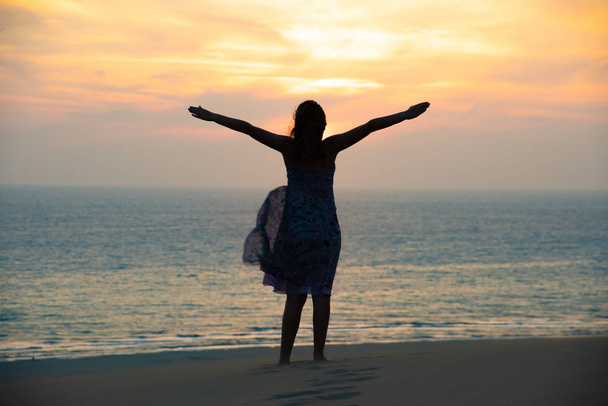 silhouette of Freedom and happy girl on beach - Φωτογραφία, εικόνα