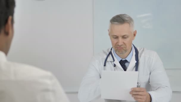 Grey Hair Senior Doctor Giving Prescription to Patient after Discussing Results - Кадры, видео