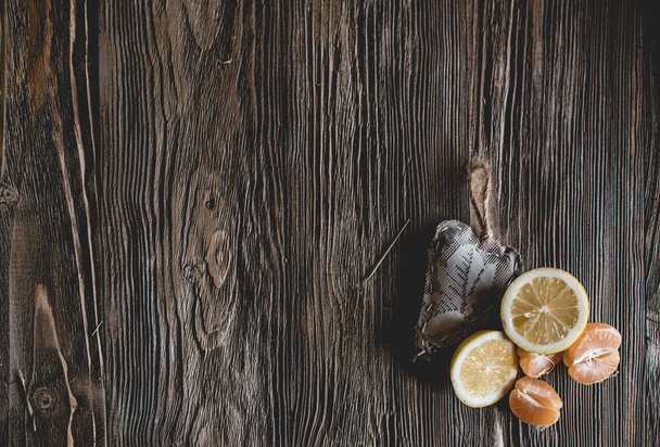 Ripe citrus with decorative heart on wooden background - Фото, зображення
