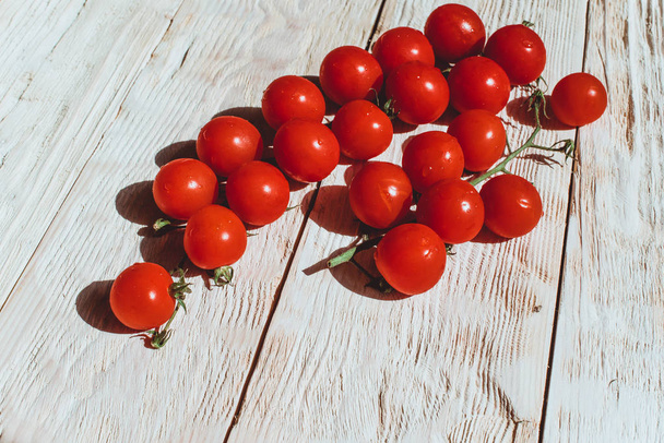 Wiśniowe pomidory na biały drewniany stół  - Zdjęcie, obraz