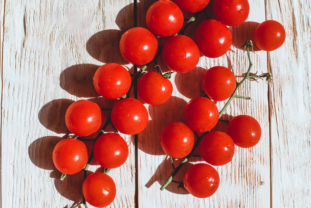Cherry tomatoes on white wooden table  - Zdjęcie, obraz