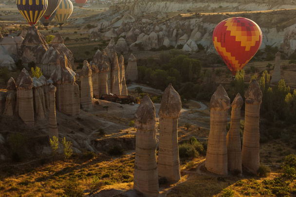Landscaoe with colorful balloons at sunrise over love valley in Cappadocia, Turkey. - 写真・画像