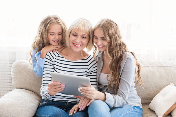 Mother, daughter and grandmother with tablet at home - Photo, Image