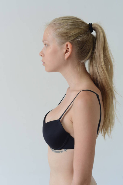 model tests girl in black lingerie with tattoo posing in Studio on grey background - Φωτογραφία, εικόνα