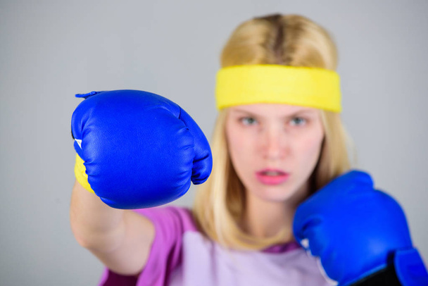 Girl learn how defend herself. Woman exercising with boxing gloves. Boxing sport concept. Cardio boxing exercises to lose weight. Femininity and strength balance. Woman boxing gloves enjoy workout - 写真・画像
