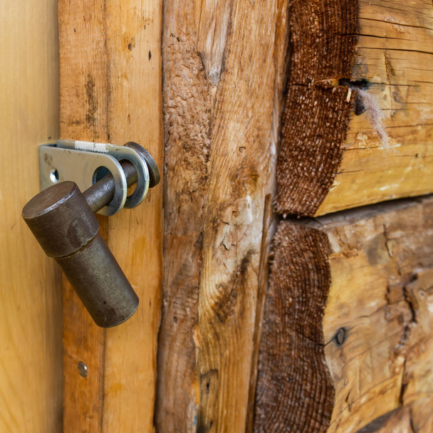 Iron lock closed the wooden door. Security, data storage. Outdated protection against apartment thieves. - Foto, afbeelding