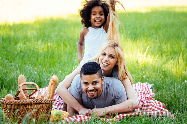 couple with their daughter having picnic - Foto, Imagem