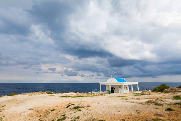 Πανέμορφο εκκλησάκι Ακρωτήριο Γκρέκο Αγίων Αναργύρων κατά τη διάρκεια συννεφιά. Τοπίο που λαμβάνονται στο νησί της Κύπρου. - Φωτογραφία, εικόνα