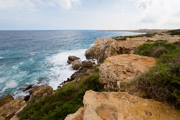 Beautiful Cape Greco Kamara Tou Koraka stone arch during cloudy weather. Landscape taken on Cyprus island. - 写真・画像