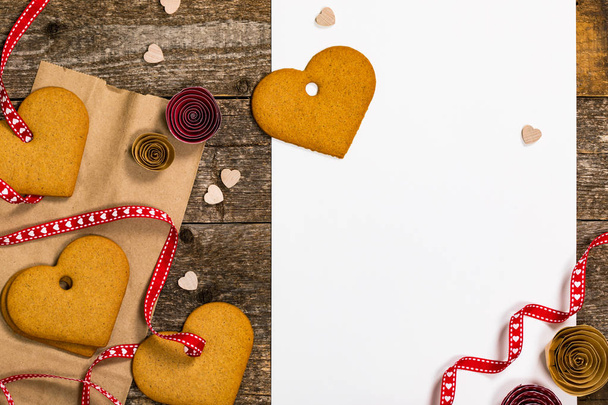 Valentines Day Heart Shaped Cookies on Wooden Background with White Paper for Text. Valentine's day cards. Selective focus. - Photo, Image