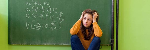 Teenager girl in math class overwhelmed by the math formula. Pressure, Education, Success concept. - Foto, Imagen
