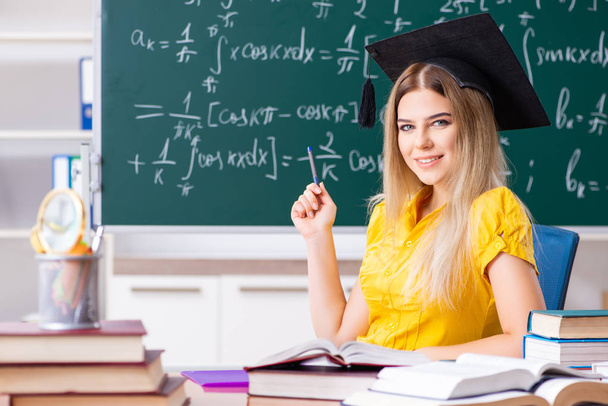 Young female student in front of the chalkboard   - Photo, Image
