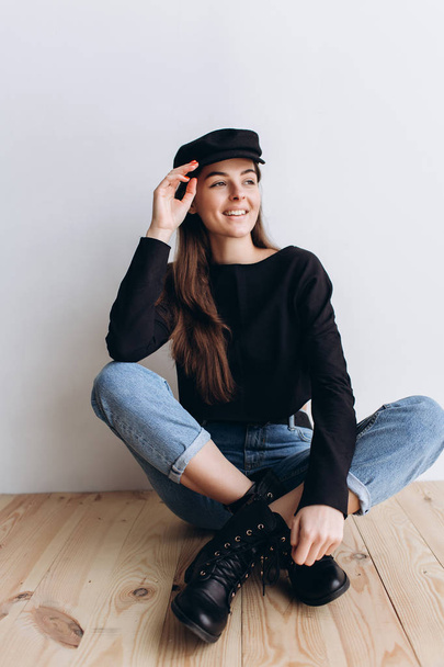 Beautiful girl in a black cap, black golf, blue jeans! Natural light, smart casua, street casual - Photo, Image