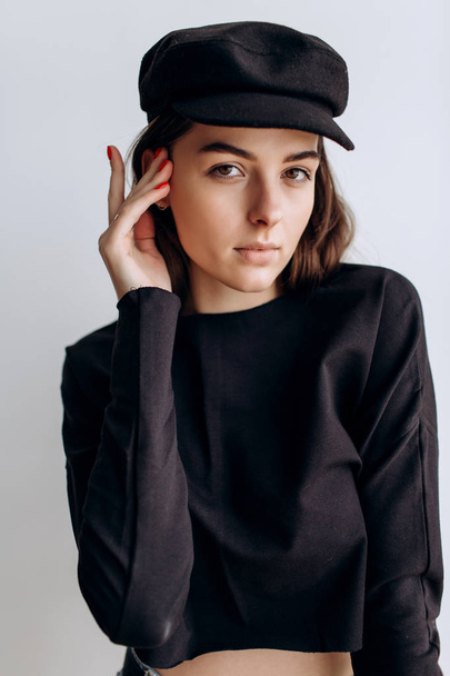 Beautiful girl in a black cap, black golf, blue jeans! Natural light, smart casua, street casual - Фото, изображение
