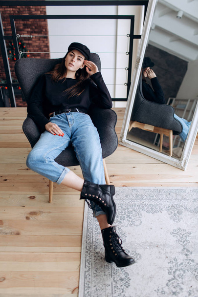 Beautiful girl in a black cap, black golf, blue jeans! Natural light, smart casua, street casual - Foto, Imagem