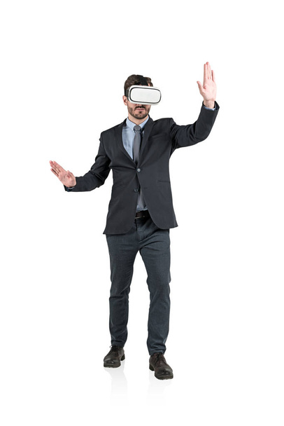 Isolated full length portrait of gesturing businessman with beard wearing virtual reality glasses. Concept of hi tech. - Фото, изображение
