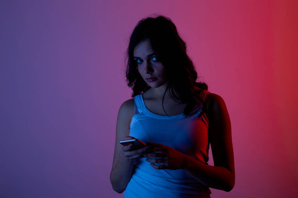 girl excessively sitting at the phone at home. he is a victim of online bullying Stalker social networks - Photo, Image