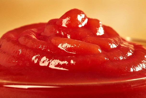 Ketchup in bowl on color background. Portion of tomato sauce.  - Valokuva, kuva